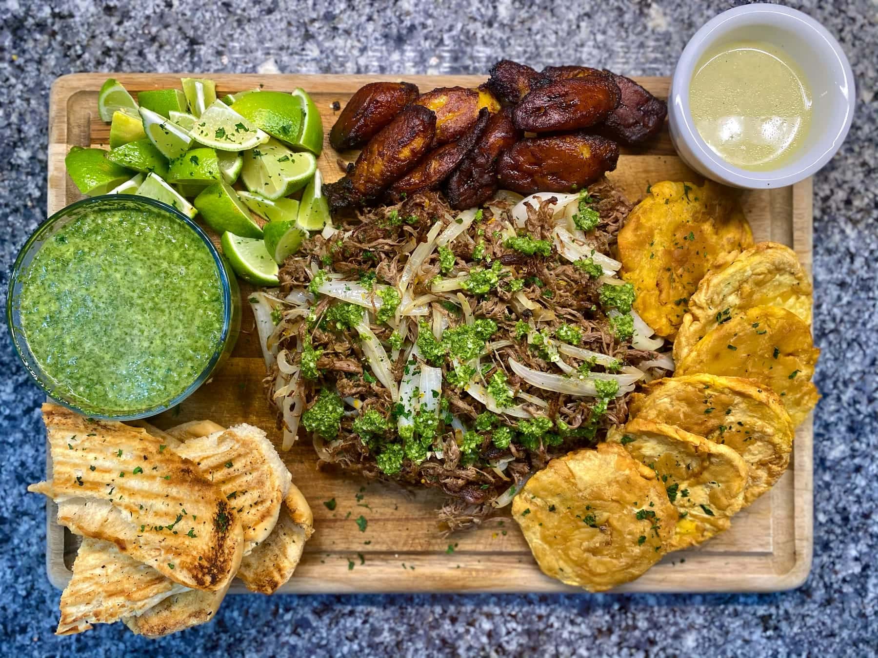 Mojo pork board with tostones, plantains, and salsa verde