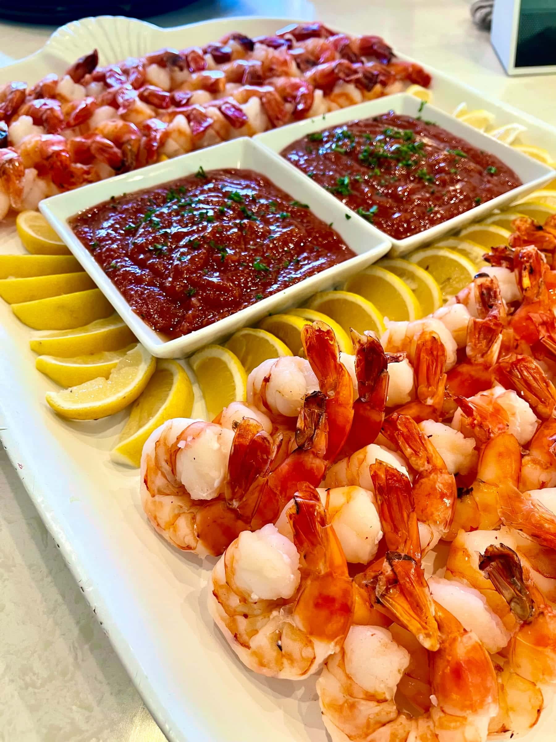Shrimp cocktail platter with lemon and cocktail sauce