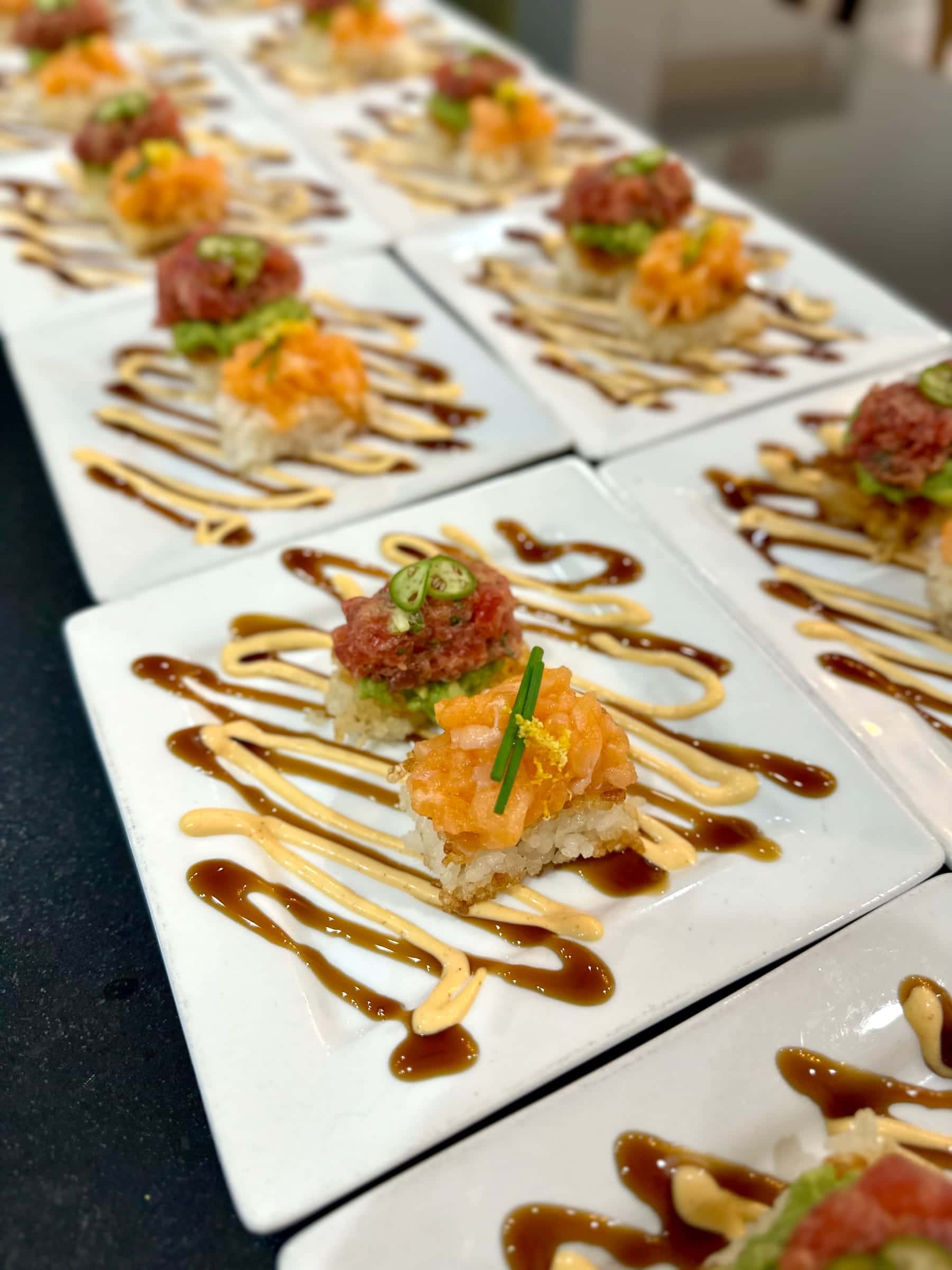 Tuna tartare canapés plated with balsamic drizzle