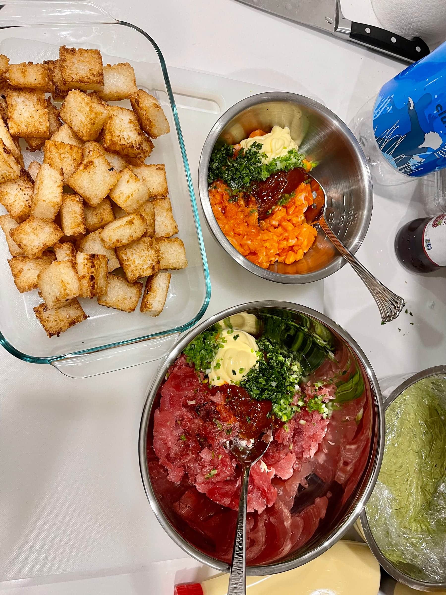 Kitchen prep station with croutons, dressings, and tartare