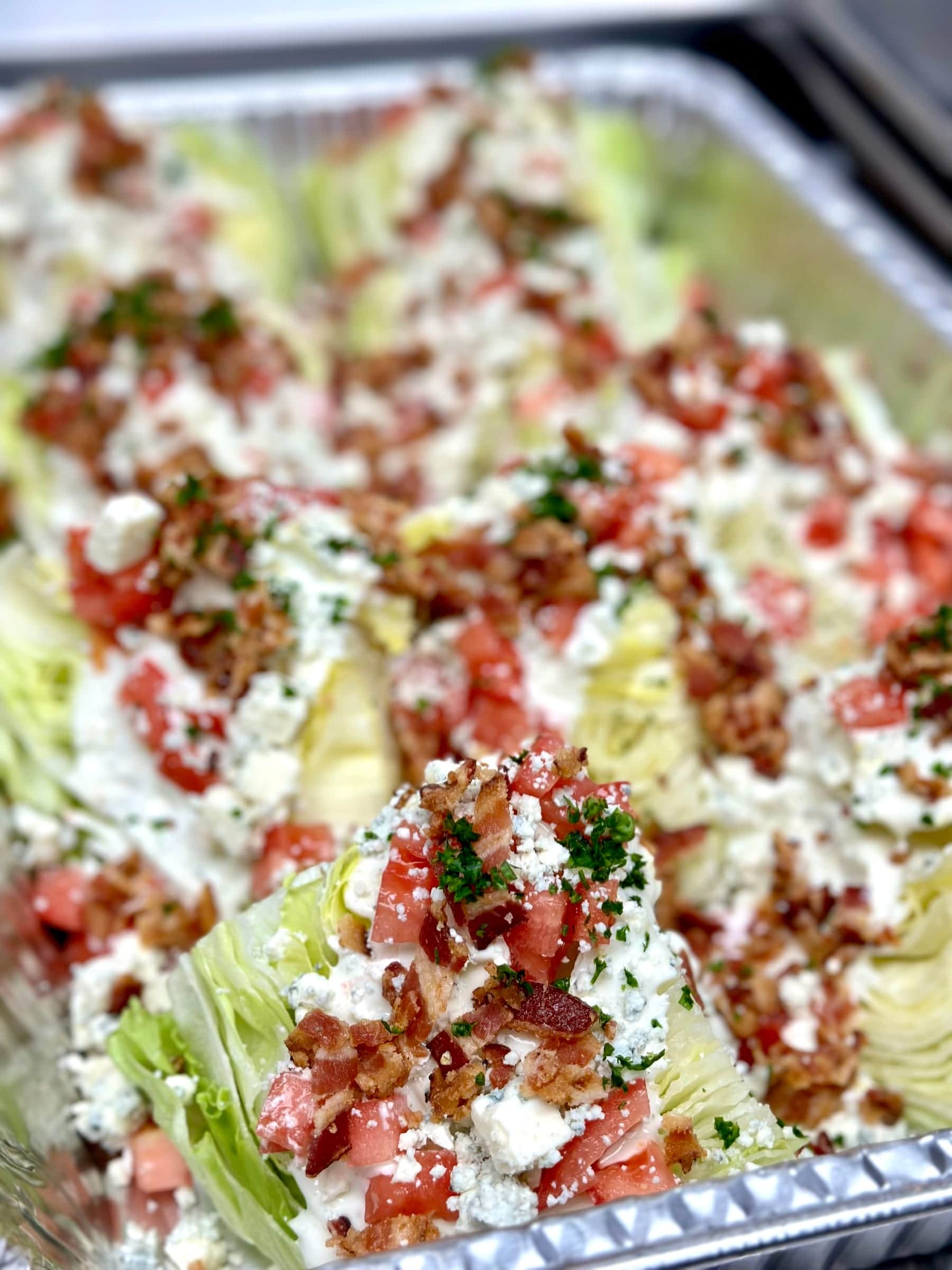 Wedge salad platter with bacon, tomato, and blue cheese dressing