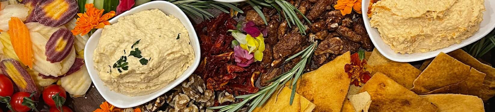 Charcuterie spread with rosemary and edible flowers