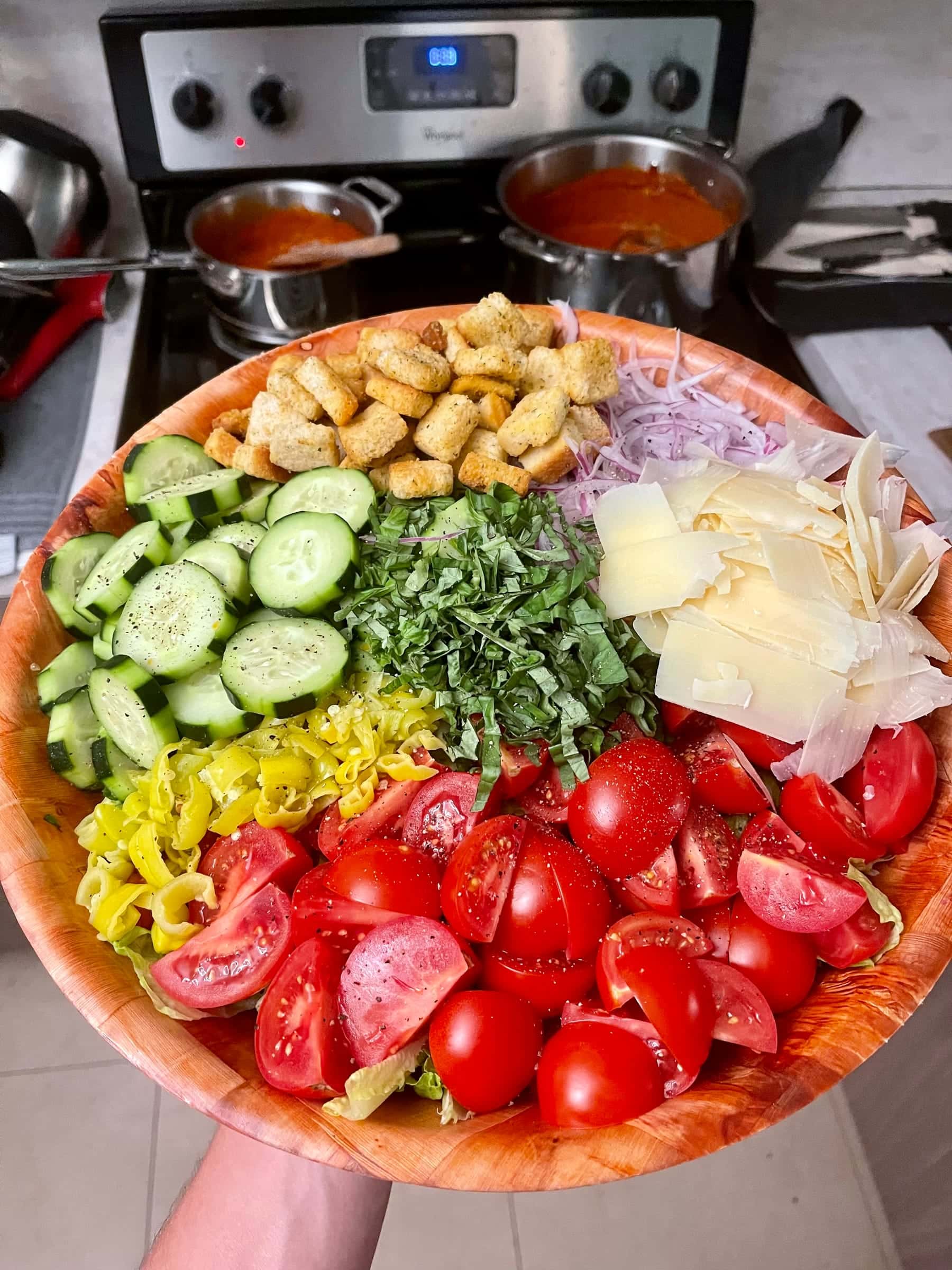 Composed chopped salad bowl with tomato, cucumber, and parmesan