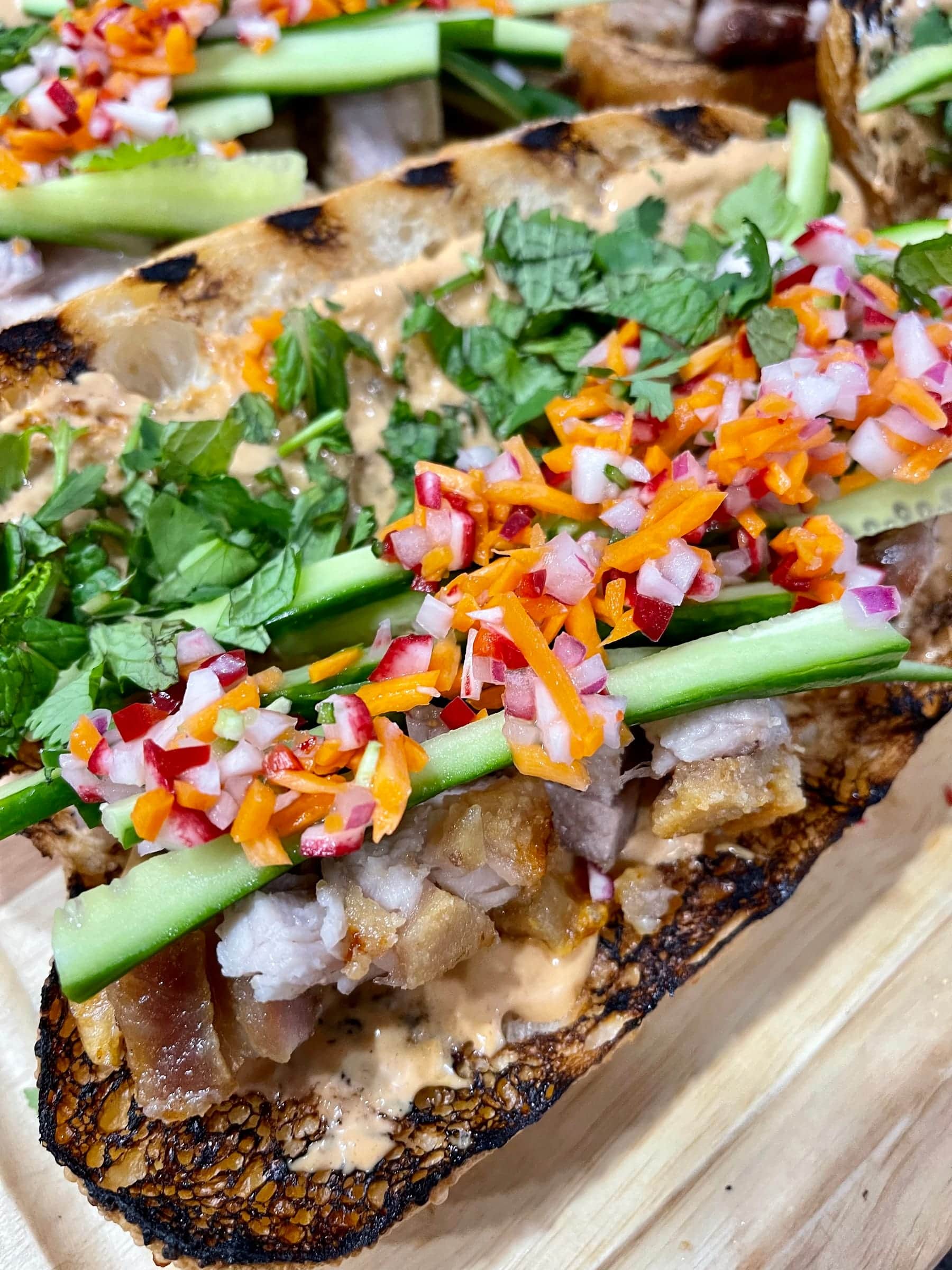 Crispy pork with pickled carrot, radish, and cucumber
