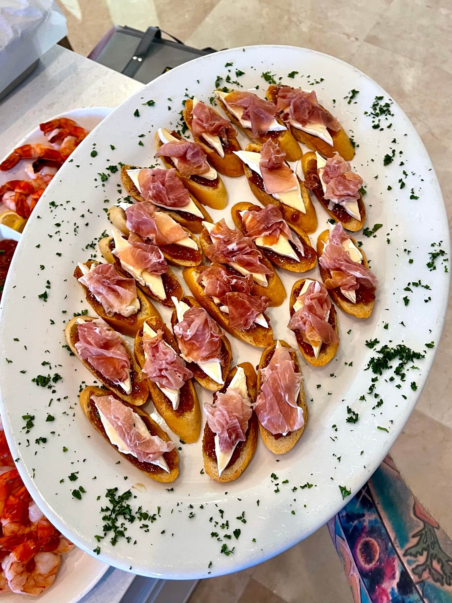 Prosciutto crostini fanned across a platter