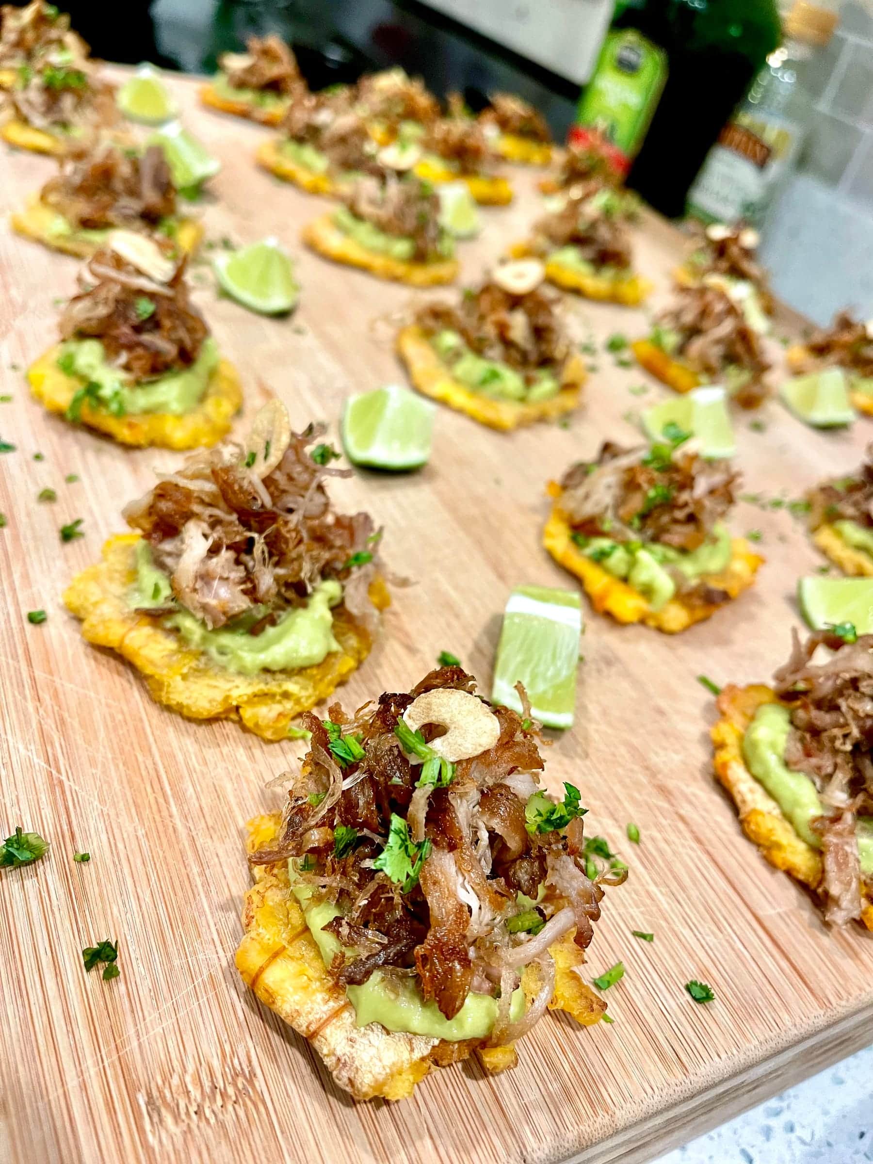 Pulled pork tostones with avocado and crispy onion