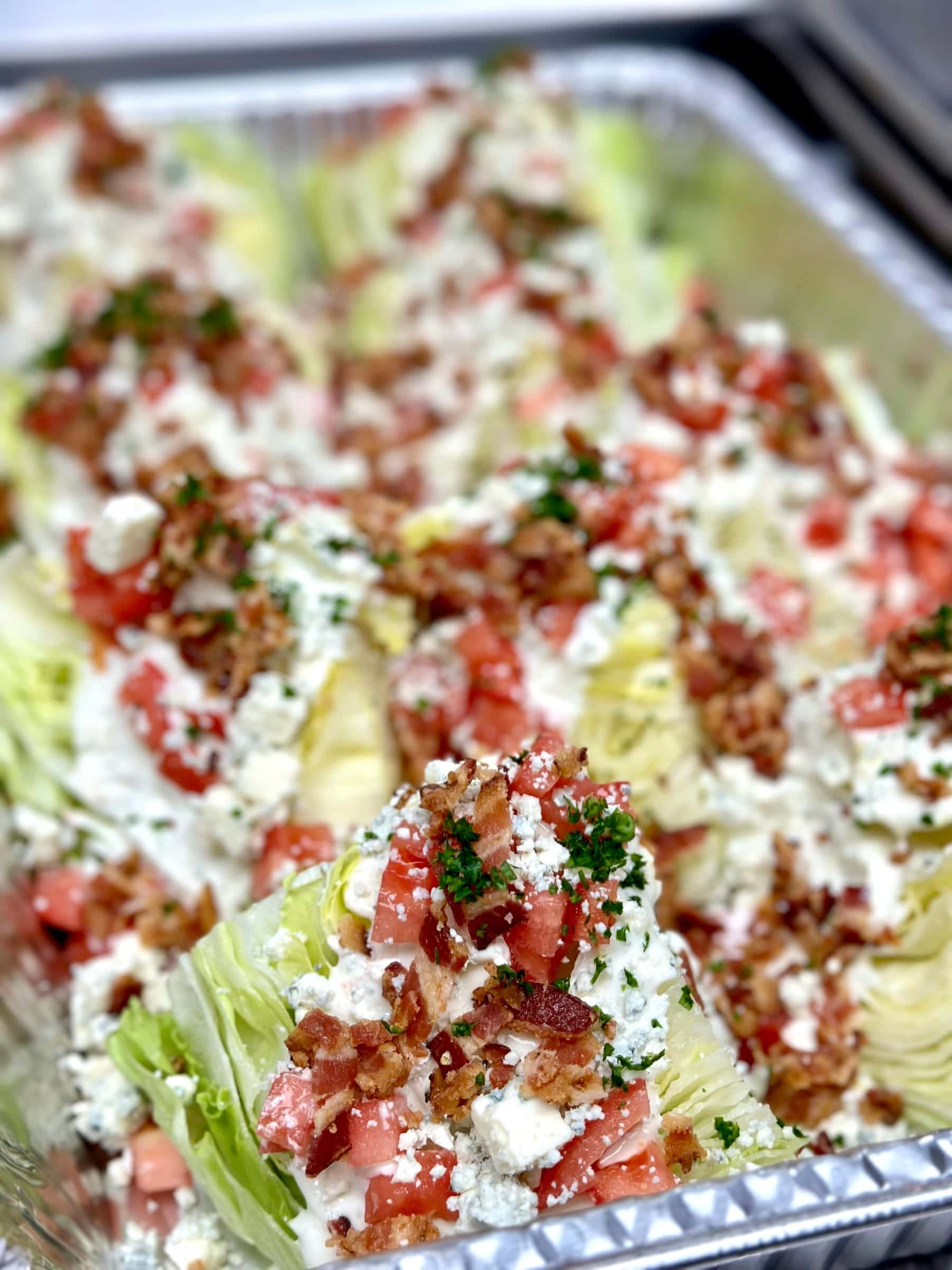 Wedge salad platter with bacon, tomato, and blue cheese dressing